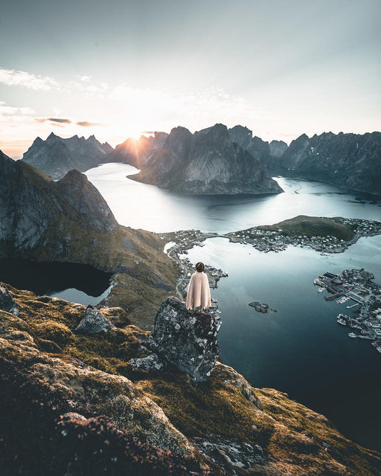 hiker-looks-out-over-bay-surrounded-by-mountains - KneeRover